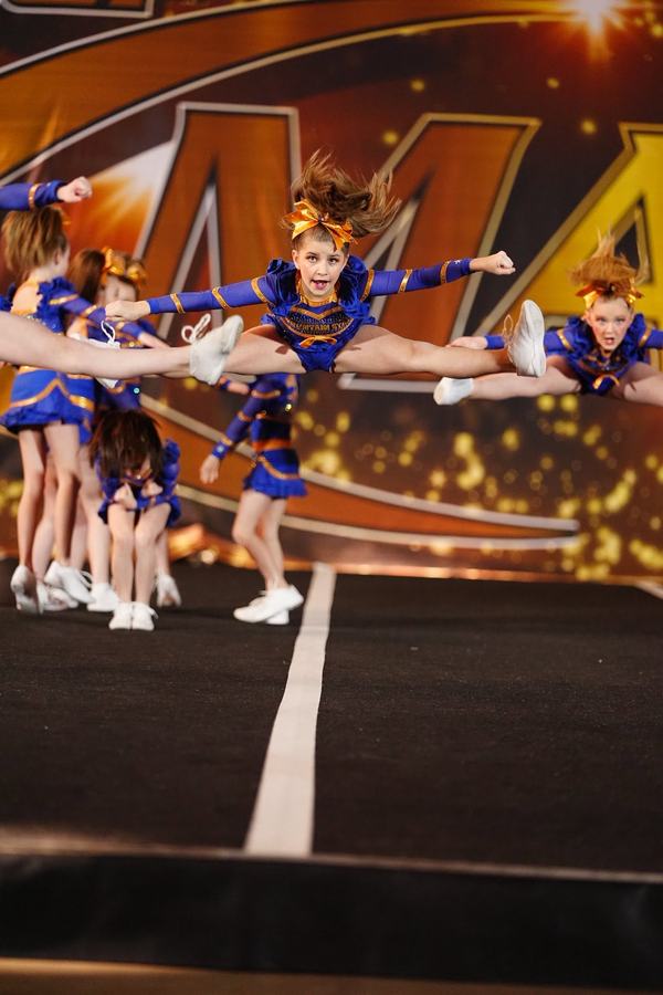 Athlete hitting a toe touch jump mid-routine