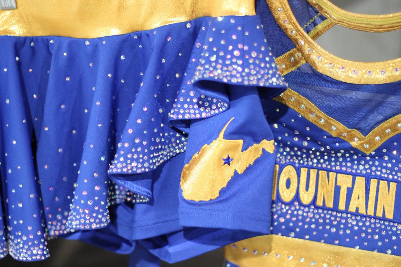 Close-up of the royal blue and gold uniform with a gold West Virginia patch