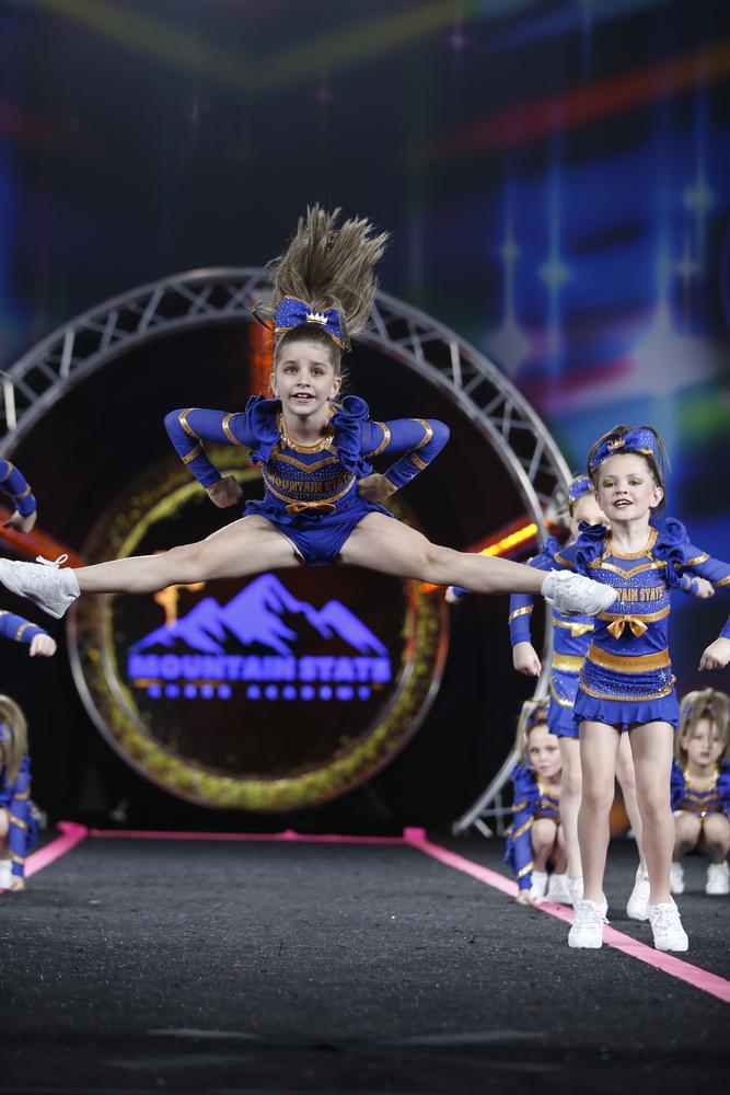 Athlete hitting a toe touch jump mid-routine